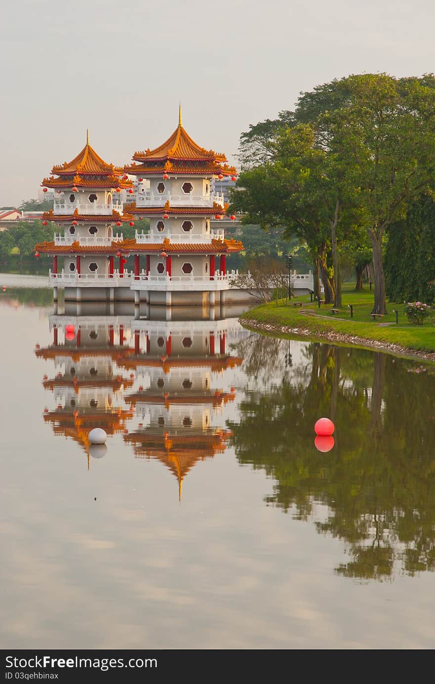 Twin Chinese pagodas with reflection in lake. Twin Chinese pagodas with reflection in lake.