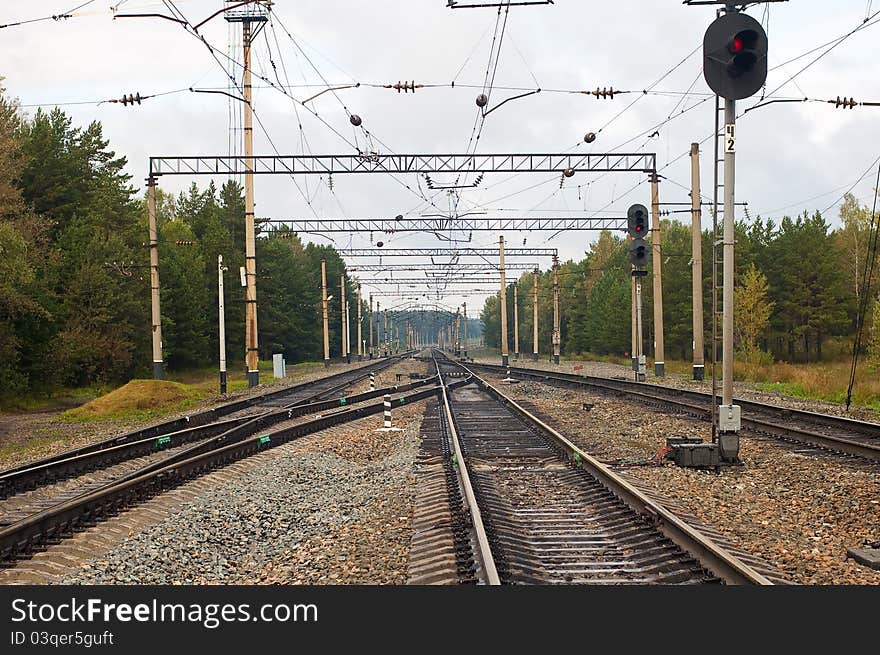 Tracks and rails with arrows and a traffic light