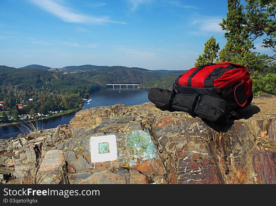 Backpacks lying on a rock at the prospect of water. Backpacks lying on a rock at the prospect of water