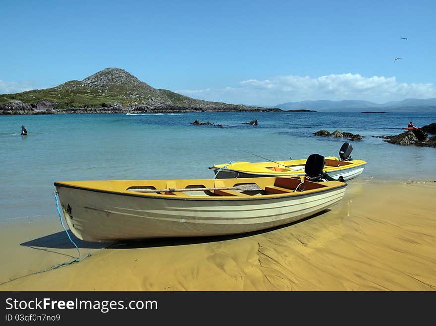 Yellow boats on golden irish beach