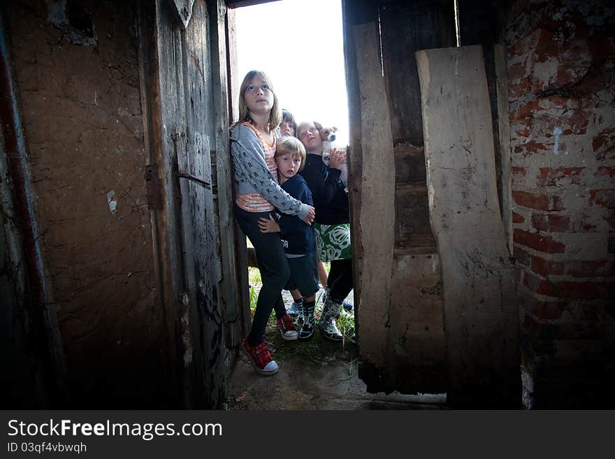 Four kids with frightened fcaces at the door of abandoned house. Four kids with frightened fcaces at the door of abandoned house