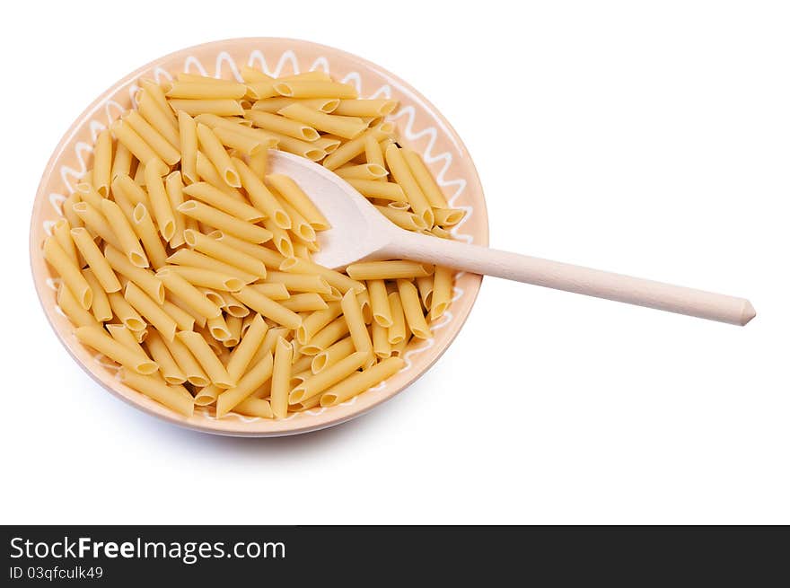 Plate with raw pasta and wooden spoon on white background. Plate with raw pasta and wooden spoon on white background.