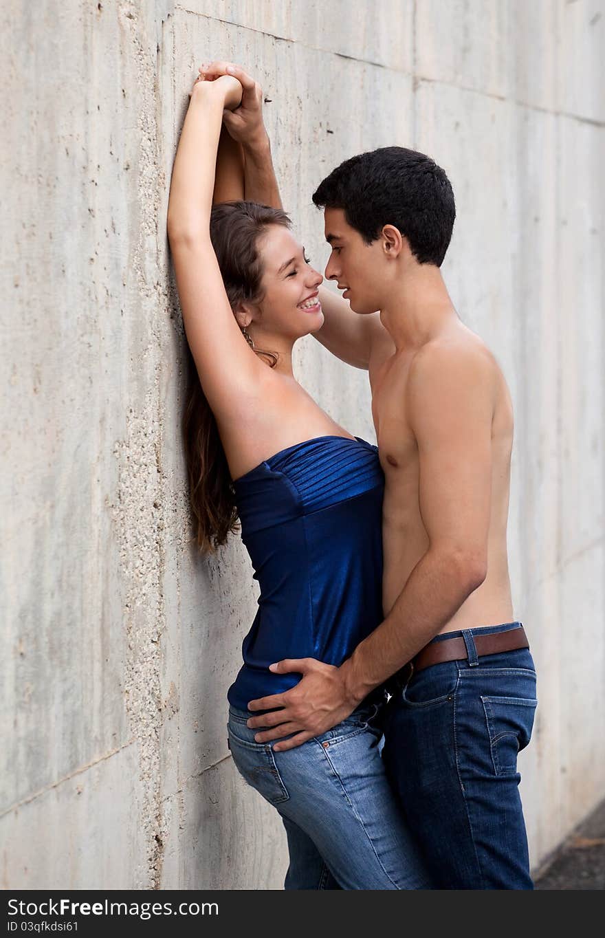 A portrait of a cute young couple, about to kiss, with the women smiling happily. A portrait of a cute young couple, about to kiss, with the women smiling happily