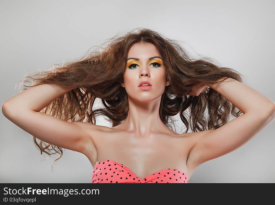 Portrait of a young brunette lady on grey background. Portrait of a young brunette lady on grey background