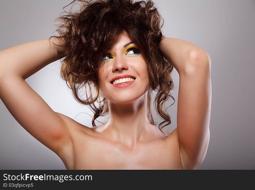 Portrait of a young brunette lady on grey background. Portrait of a young brunette lady on grey background