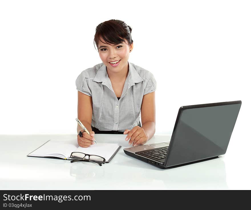 Young business woman working with laptop. isolated over white background. Young business woman working with laptop. isolated over white background