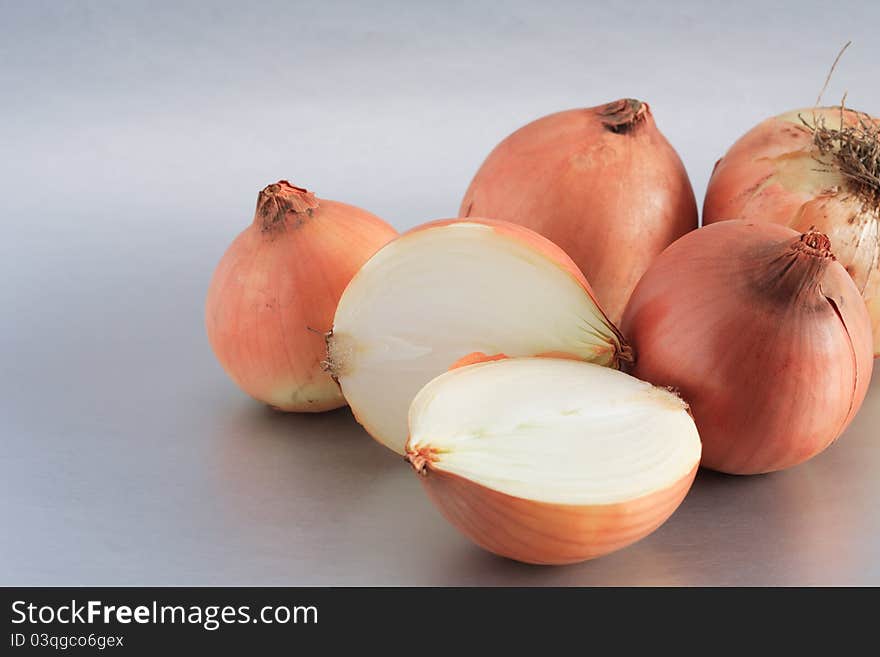 Closeup of few onions on beautiful gray background. Closeup of few onions on beautiful gray background