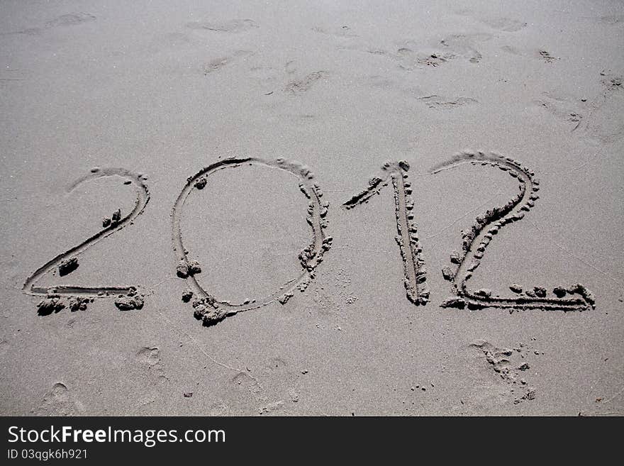 New year 2012 on the beach written on the sand