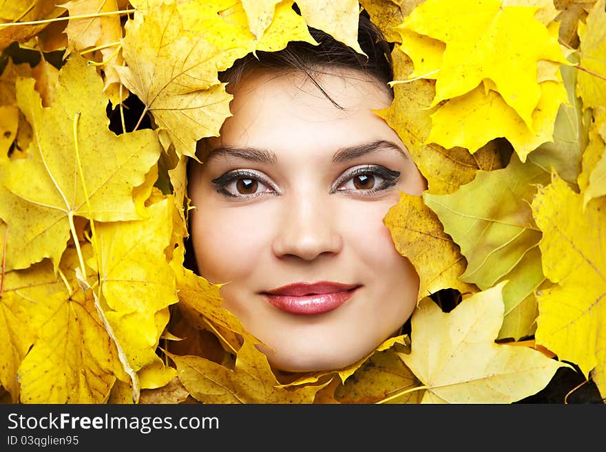 Portrait of the young woman in autumn leaves. Portrait of the young woman in autumn leaves.