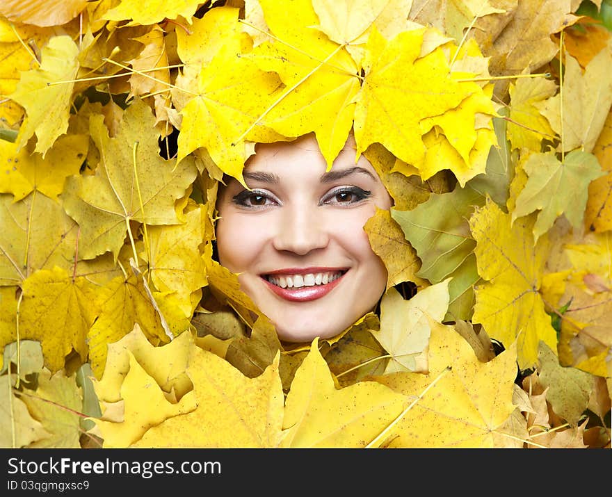 Portrait of the young woman in autumn leaves. Portrait of the young woman in autumn leaves.