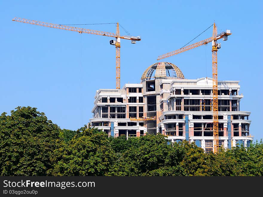 Construction site with cranes and blue sky