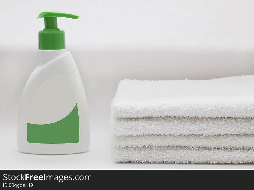 Liquid soap and towels on white. Liquid soap and towels on white