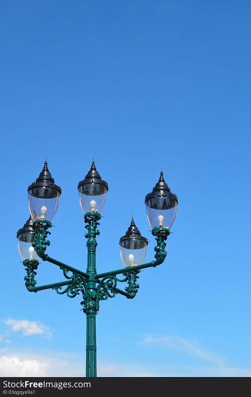 An old antique lamp with the sky.