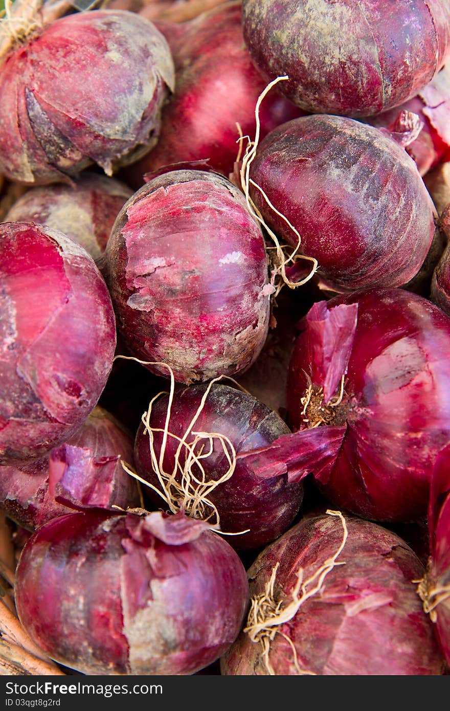 Red onions in a basket for sale at a farmer's market