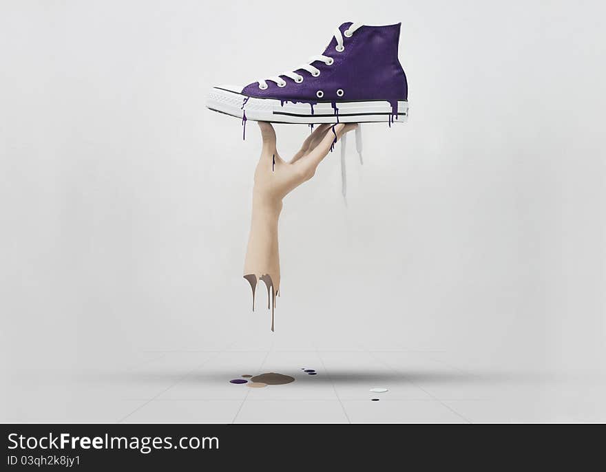 A hand holding a purple sneaker, melted all over the floor. A hand holding a purple sneaker, melted all over the floor.