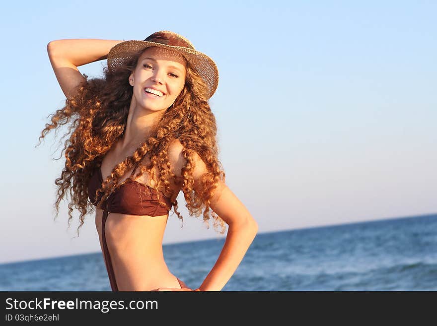 Young smiling woman on sea background