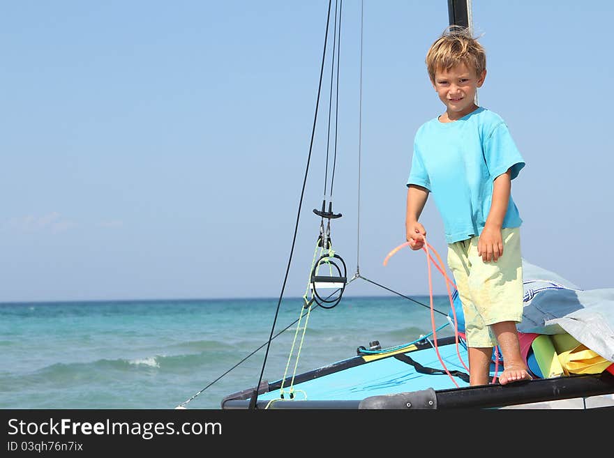 Boy on board of sea catamaran