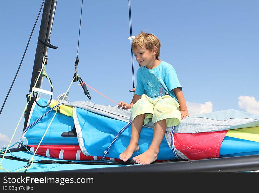 Boy on board of sea catamaran