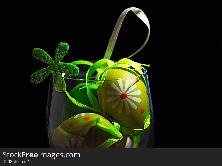 Easter eggs in a glass isolated on black