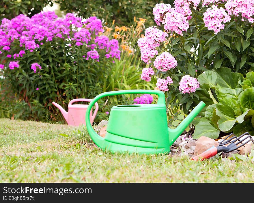 Two watering cans for watering is in the garden