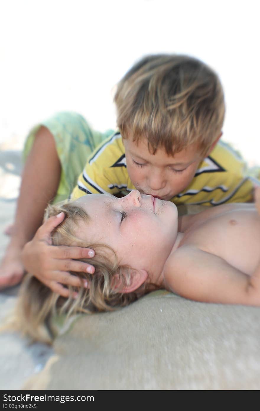 Brother kissing his younger sister, partly isolated over white. Brother kissing his younger sister, partly isolated over white