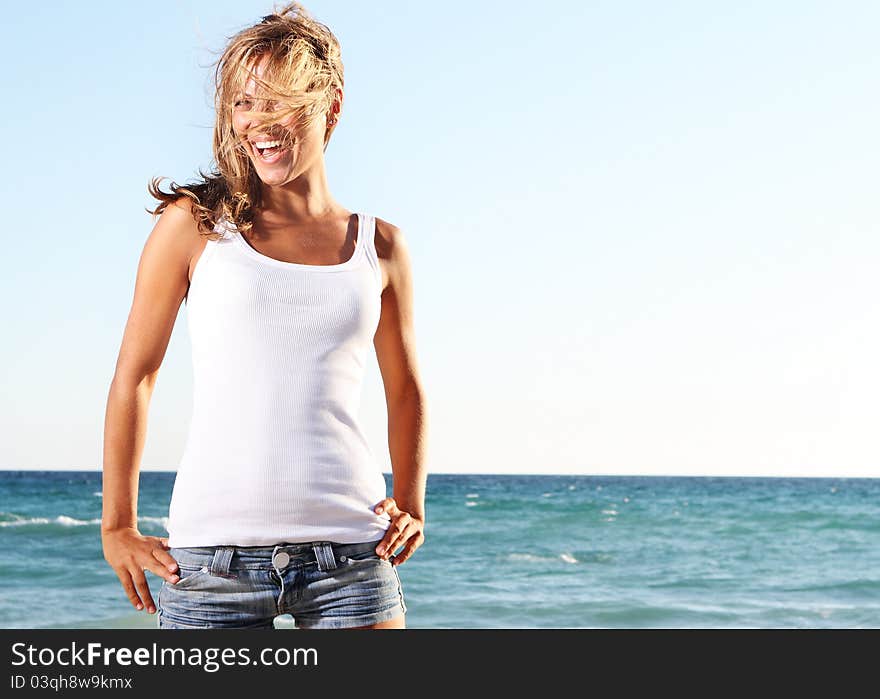 Young happy woman on sea background. Young happy woman on sea background