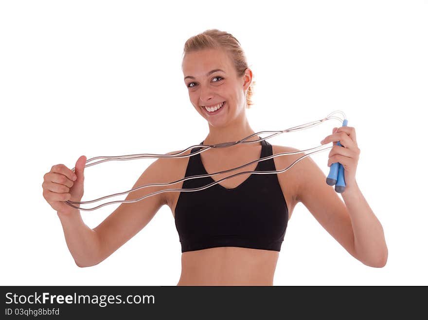 A young beautiful girl with a skipping rope in her hand. A young beautiful girl with a skipping rope in her hand