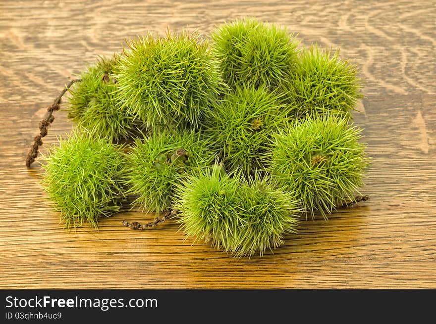 Sweet Chestnut on wooden background.