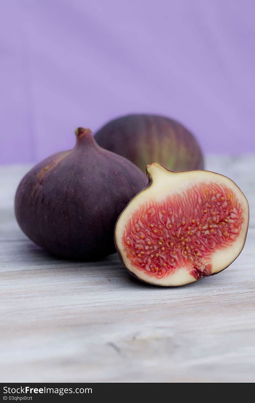 Three figs and a half lying on a table