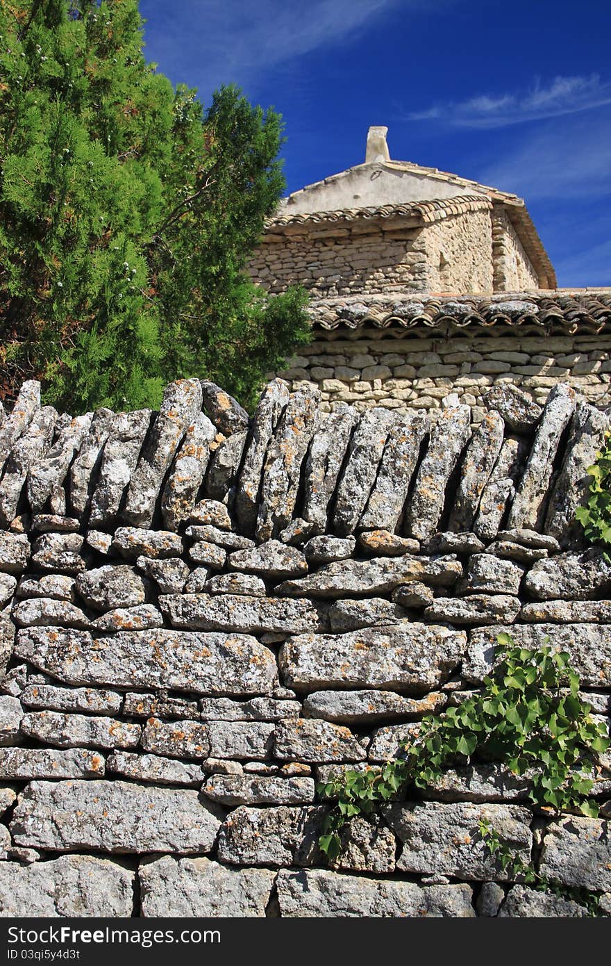 Old stone wall of a house in Southern France. Old stone wall of a house in Southern France