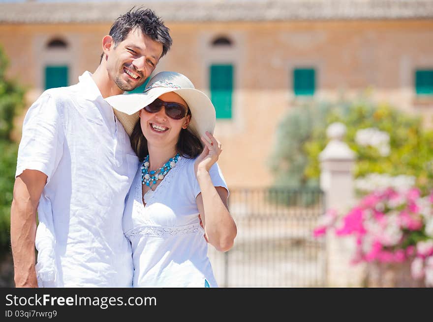 Closeup portrait of happy couple standing in front of the villa. Mallorca. Spain. Closeup portrait of happy couple standing in front of the villa. Mallorca. Spain