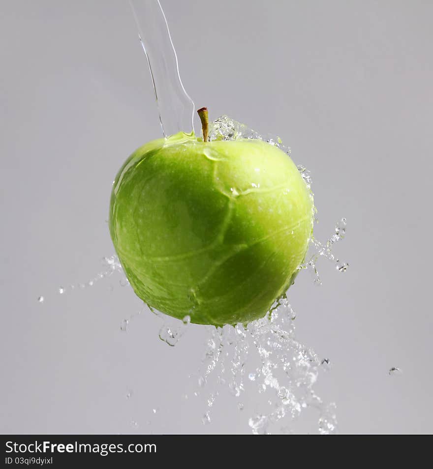 Green apple in a waterfountain