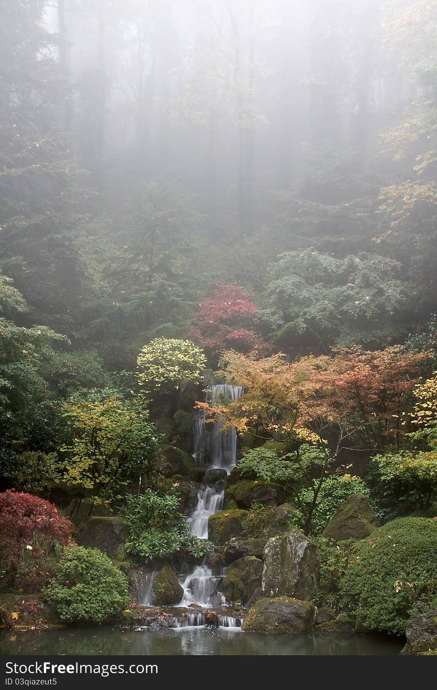 Waterfall at Japanese Garden in Fall Foggy Morning