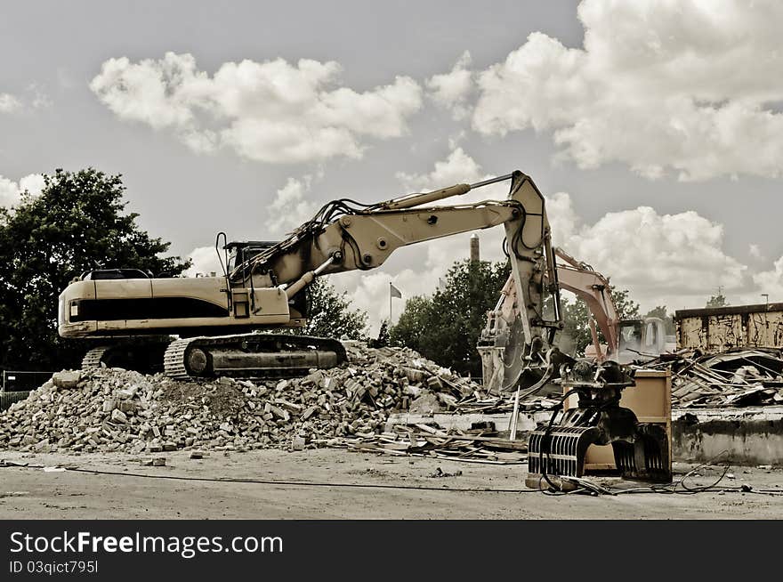 Two excavators working in demolition area