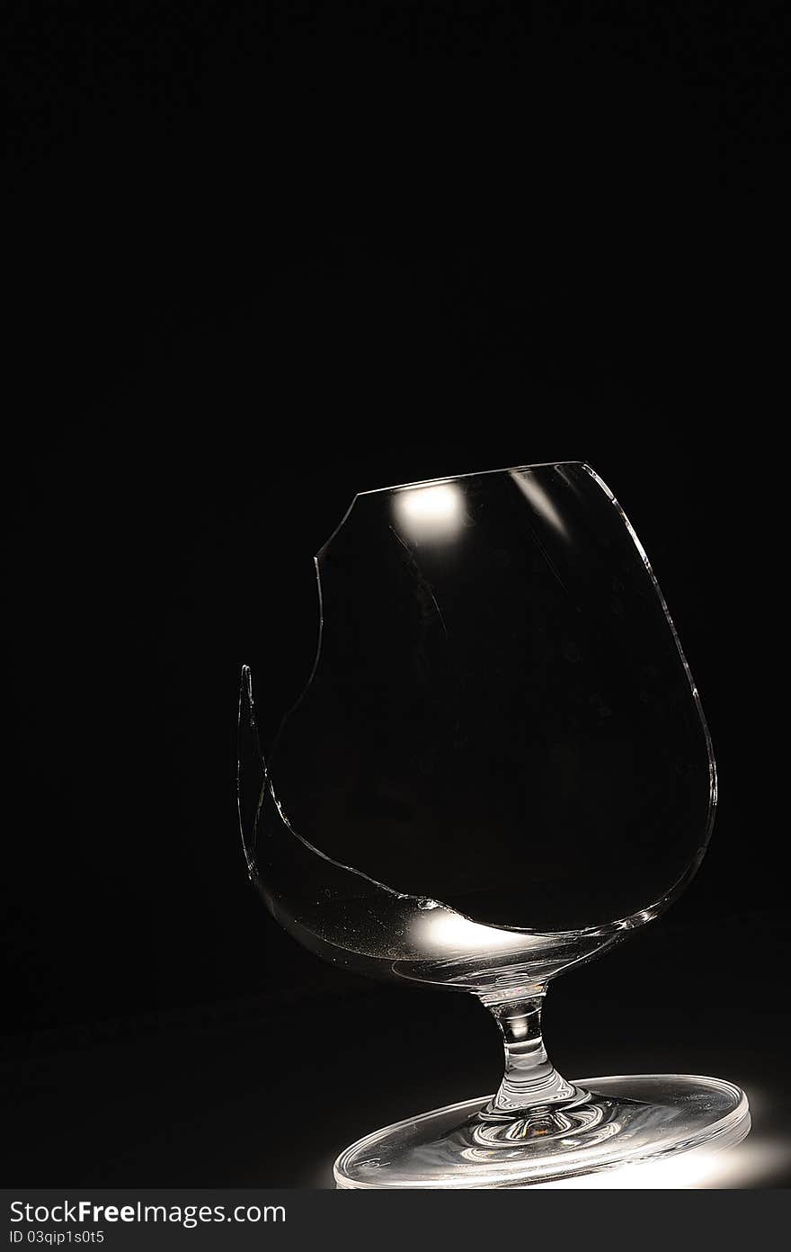 Broken wine glass on a black background