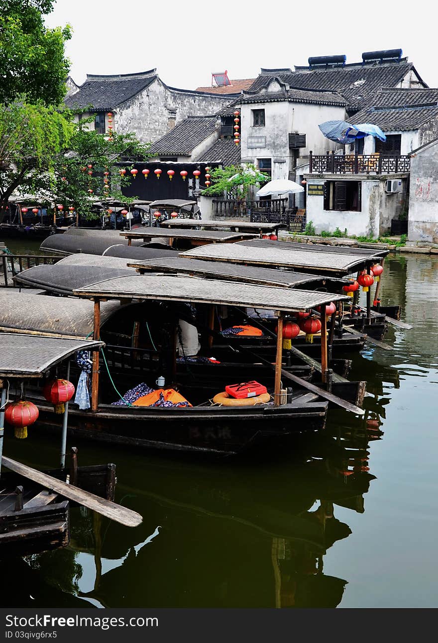 Old water town , some old boats on river， which reflecte on the river in early morning. Old water town , some old boats on river， which reflecte on the river in early morning