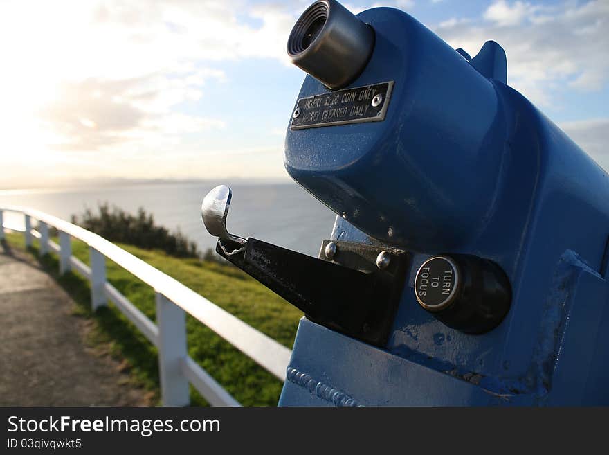 Spyglass with sunset and ocean in the background.