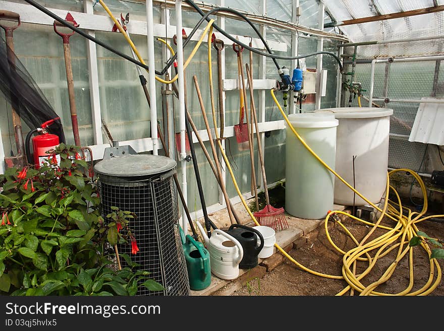 Gardening garden tools on a wall of a greenhouse agriculture hobby background