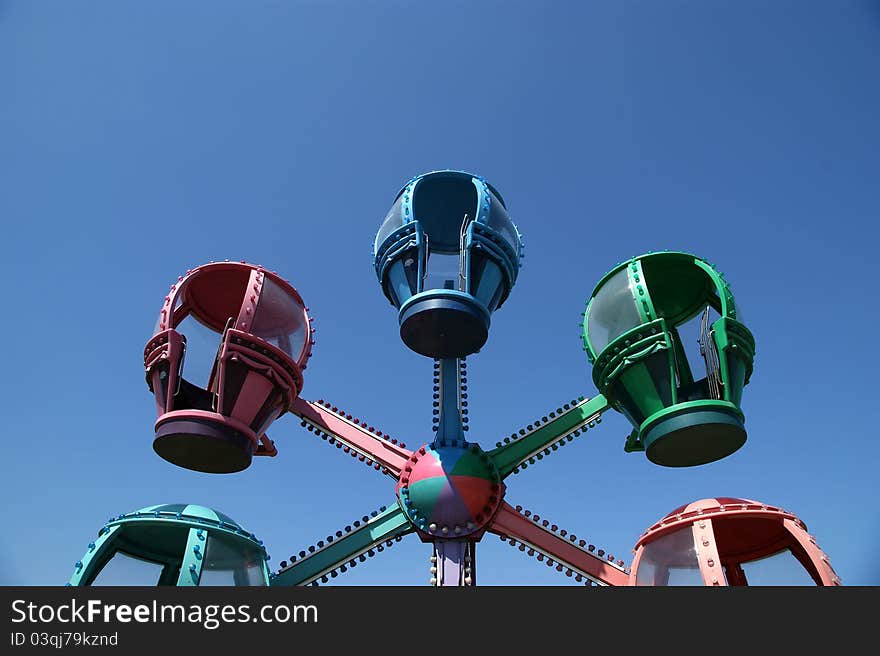 Booths children carousel at the blue sky