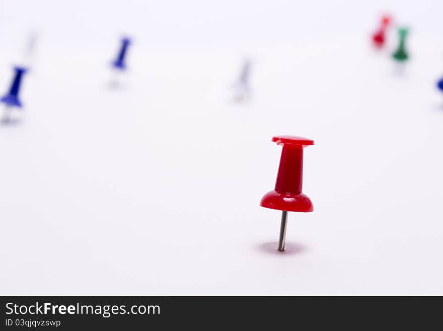 Red push pin on a white background close-up