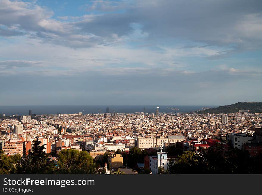 View of sunny Barcelona with sea and Montjuic mountain