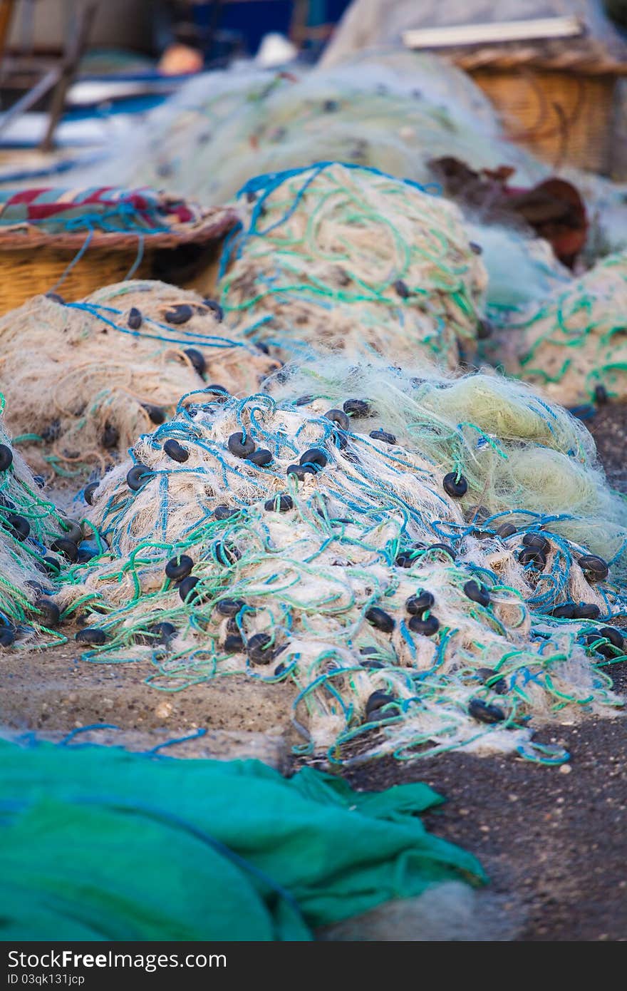 Piles of fishing nets on the harbour pier at Yumurtalik, Turkey.