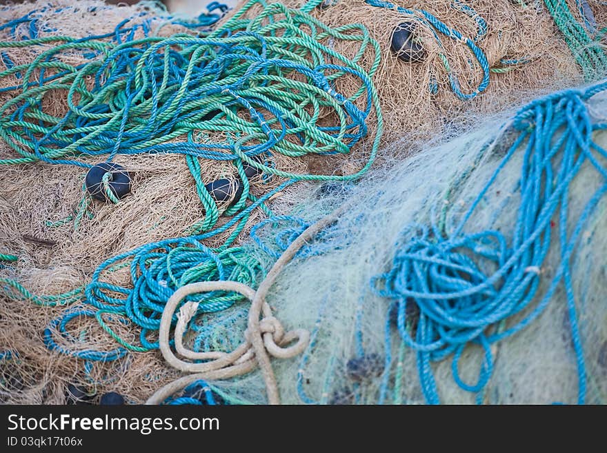Piles of fishing nets on the harbour pier at Yumurtalik, Turkey.
