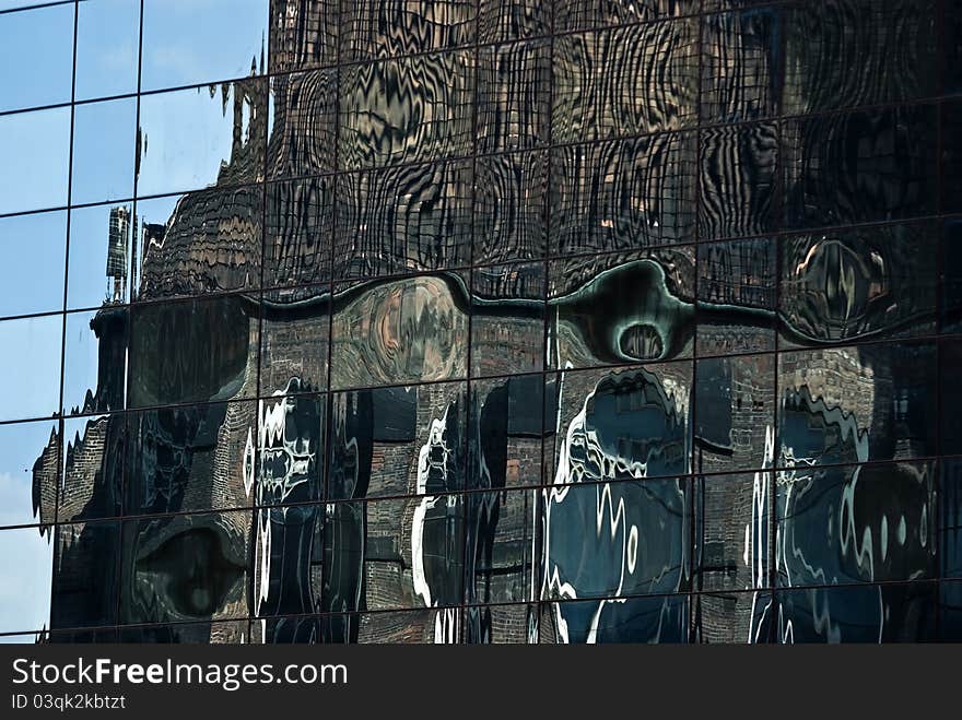 Reflections of old architecture in a glass wall of a modern building. Reflections of old architecture in a glass wall of a modern building