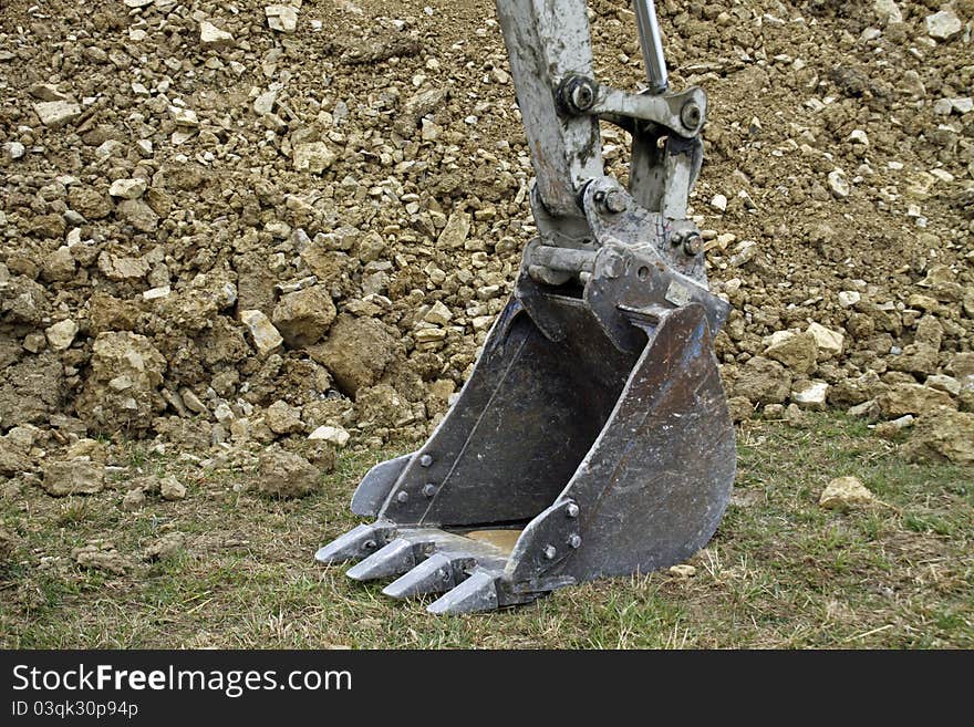 An excavator shovel, standing on the ground. An excavator shovel, standing on the ground