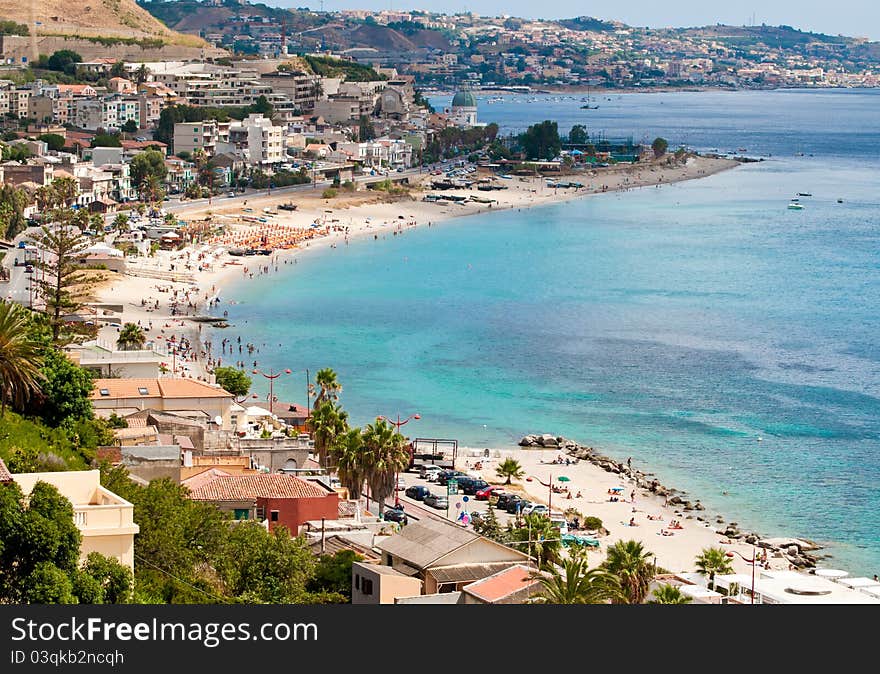 Tourists crowding the beaches on the coast of the Strait of Messina, in Sicily. Tourists crowding the beaches on the coast of the Strait of Messina, in Sicily