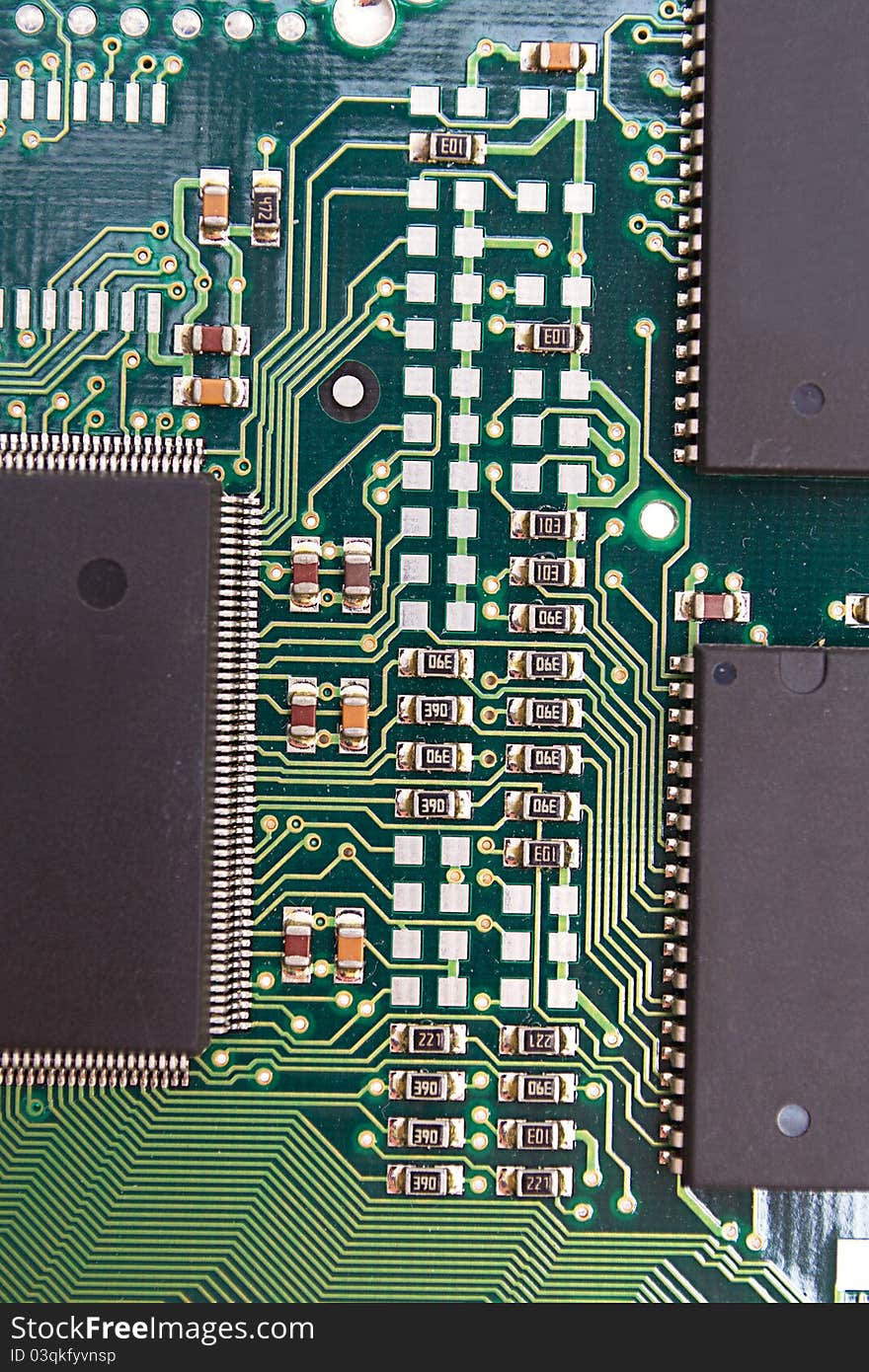 Green circuit board with components.