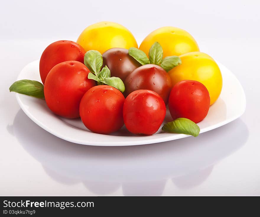 Variety of tomatoes with fresh basil