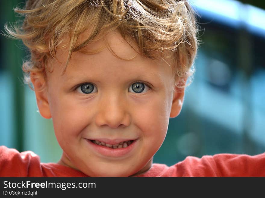 A blond child that smiling to you. A blond child that smiling to you