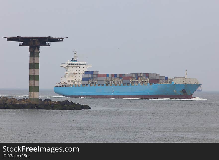 Containership entering the harbour of rotterdam